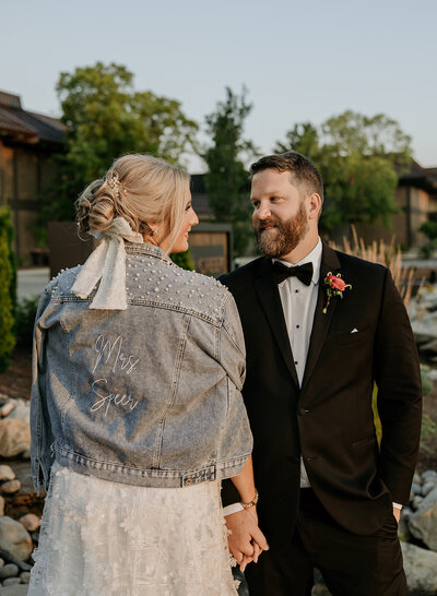 bride and groom looking at eachother during outdoor bridal portraits