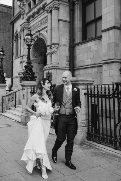 A bride and groom walking through London