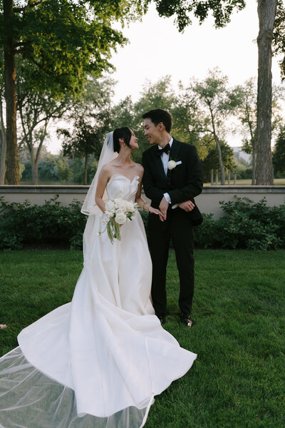 bride in white wedding dress dancing and partying at reception with friends