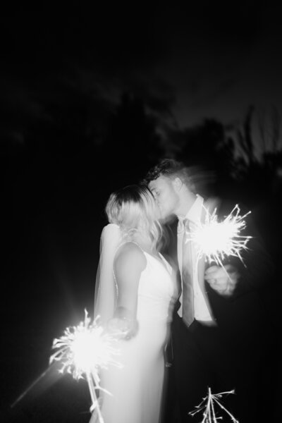 saint louis wedding couple kissing while holding sparklers