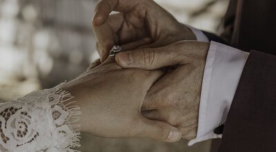 Groom putting brides wedding  ring on finger