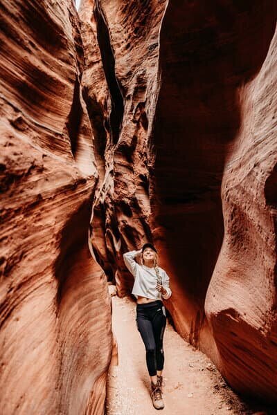 a sedona elopement photographer standing in antelope canyon