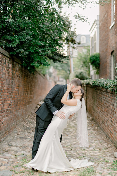 Groom dip kissing his bride at an Old Town Alexandria wedding venue.