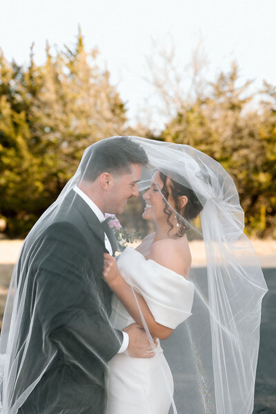 bride and groom embrace after wedding in kansas city