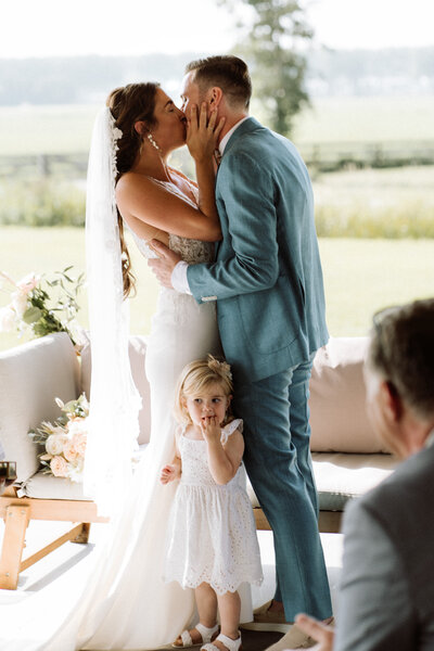 Prachtige intieme bruiloft bij Nigtevecht Freeland Farm, vol liefdevolle en authentieke momenten in een rustige, landelijke setting. De kus tijdens de ceremonie. 