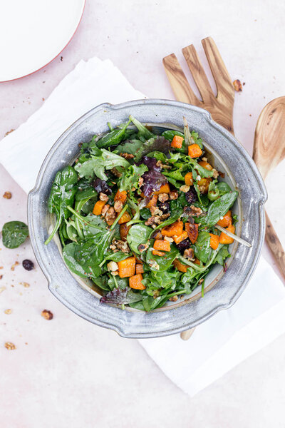A salad in a decorative bowl on the counter. 