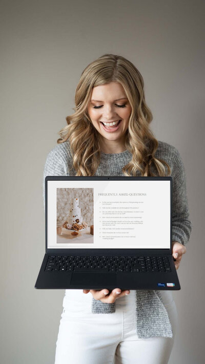 Showit website designer for photographers holding an open laptop