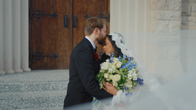 Bride and groom kneel at the alter in beautiful bright Catholic Church. Photo taken by  Orlando Wedding Photographer Four Loves.