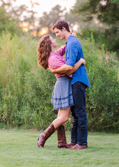 young couple in tall grass wearing boots