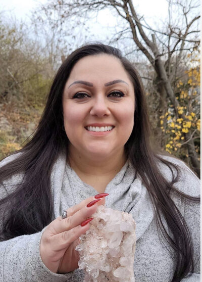 woman outside holding crystal for sale,