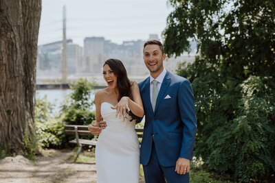 bride and groom smiling joyfully bride showing her ring