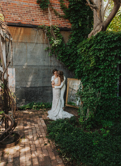 Brides standing from of a welcome sign mirror with calligraphy