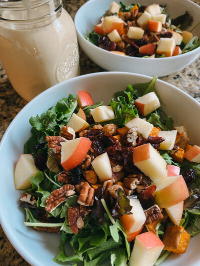 Image of a salad with pecans and apples.