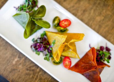 A trio of colorful tortilla appetizers shaped like dumplings prepared by Chef Jenny Ross for food photography branding session at 118 Degrees.