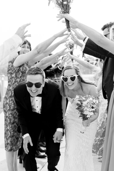 Bride and groom laughing together at an engagement session by Lake Michigan