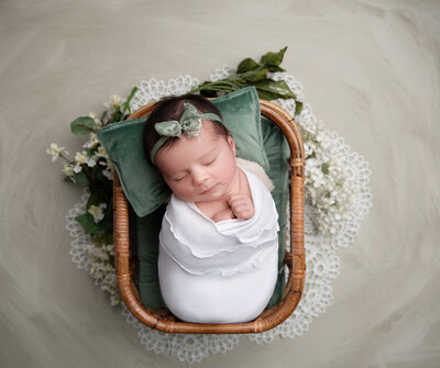 Infant in heart bowl for a Newborn Photo Session