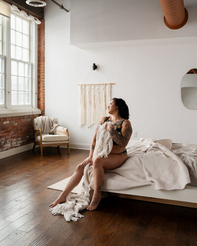 A studio boudoir session  with bed sheets in Buffalo, NY.
