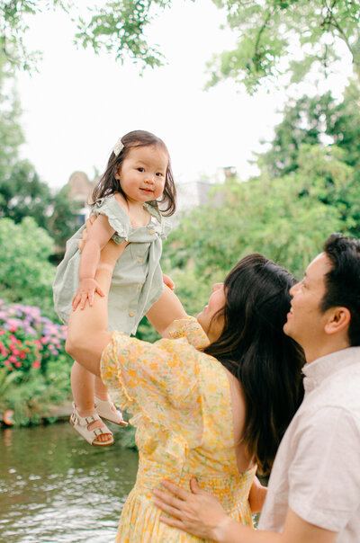 Baby girl smiles for a family photo taken by amsterdam photographer, sim sawyers