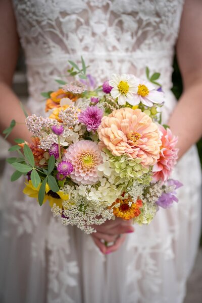 bridal bouquet ifull of wild flowers n bride's hands