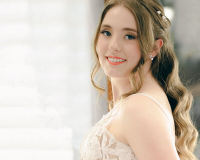 A bride looks at the camera in an elegant photograph by Beth Sheridan wedding photography.