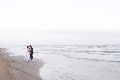 two brides kiss on the beach on their wedding day in Galveston Texas by Swish and Click Photography