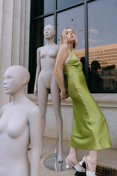 woman standing by mannequins