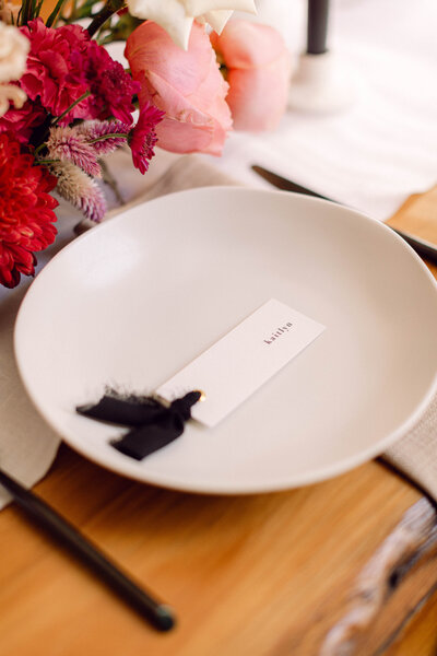 Close-up of an elegant wedding reception place setting featuring modern tableware and neutral tones at an intimate backyard wedding in Richmond, Virginia.