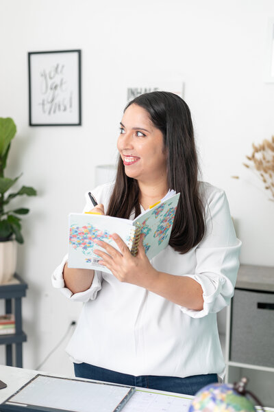 Woman writes in a planner