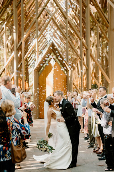 newlyweds kiss in aisle