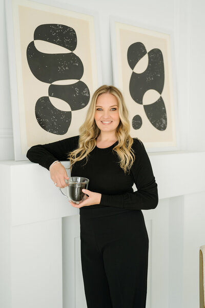 Photo of a woman holding a coffee at Mint Room Studio