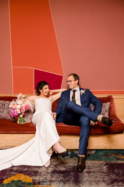 Couple relaxing at the Grass Room on their wedding day in the pink and red bridal suite 
