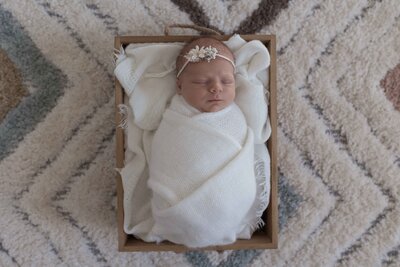 newborn photographer holding camera and smiling in Fargo