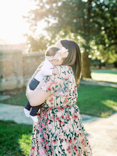 A mom holding a baby by Katie Stansfield Photography, a Richmond family photographer.