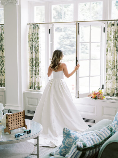 Elegant wedding arrival at Dover Hall Estate featuring a white horse-drawn carriage and brick architecture