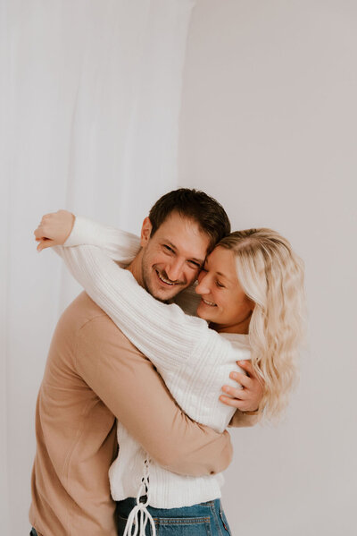 couple embraces for family portraits in peoria il
