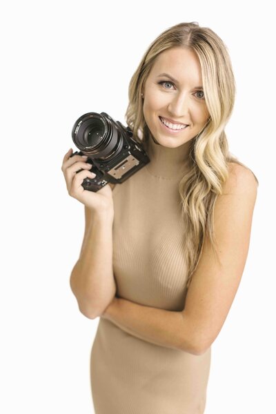 photographer posing with camera