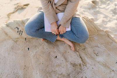 Allie Marie Smith, writing in her journal on the beach