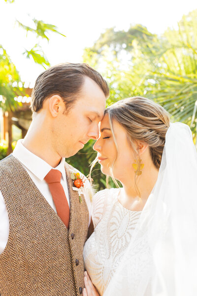 Bride and groom on their colorful wedding day in Santa Cruz, California in the redwood trees.