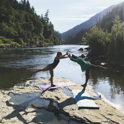 two retreaters at the edge of the river