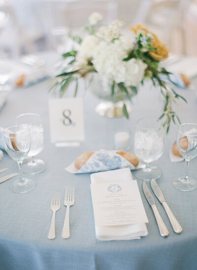 A bride cradles her bouquet of peonies in an etherial photograph by Beth Sheridan wedding photography.