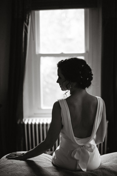 Portrait of the bride by herself preparing to walk down the aisle to marry her best friend.