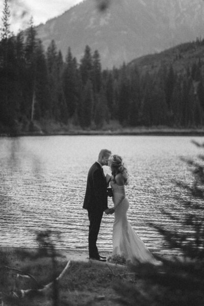 Photo of a bride and groom on the beach during their non-traditional beach wedding with close family and friends
