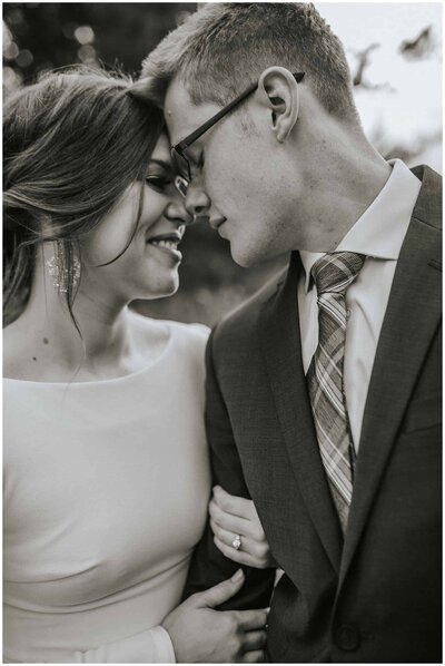 Sacramento Wedding Photographer captures black and white portrait of bride and groom touching foreheads