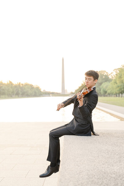 boy playing violin during Loudoun County, Virginia senior photo