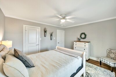 Bedroom with Queen size sleigh bed in this four-bedroom, three-bathroom vacation rental home with game room, spa, and firepit located on the edge of Waco, TX.