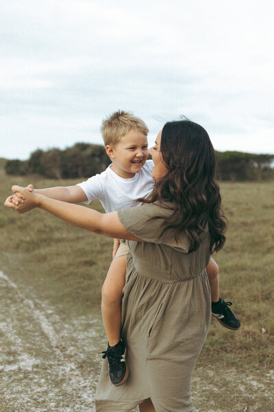 Mother and Child dancing around in a Field in Evans Head NSW