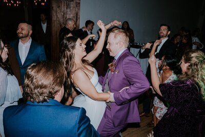 Minnesota Wedding Photographer captures bride and groom holding hands at indoor wedding venues