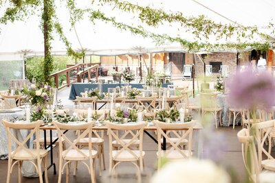 Reception details with hanging greenery and candles at Blackstone Rivers Ranch wedding venue.