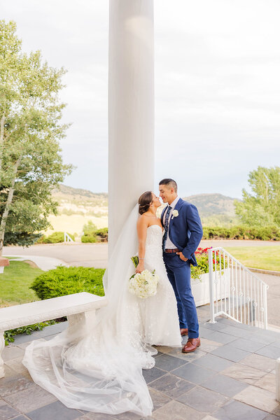 Bride and groom sharing an intimate moment on their wedding day at The Manor House in Littleton, Colorado.