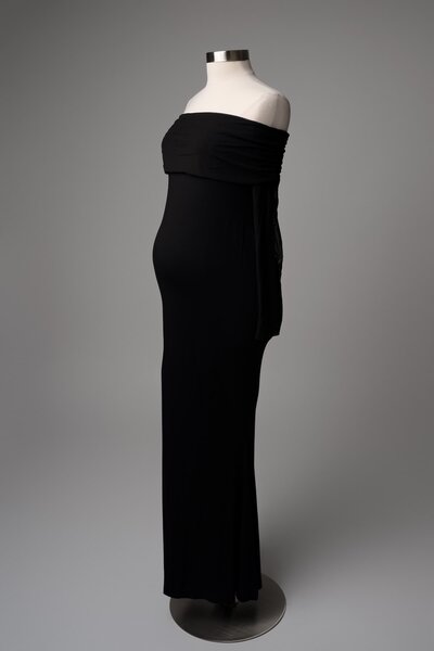 Strapless black gown styled on mannequin with classic silhouette